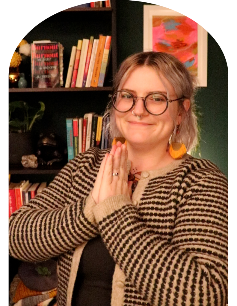 non-binary person puts their hands together in gassho